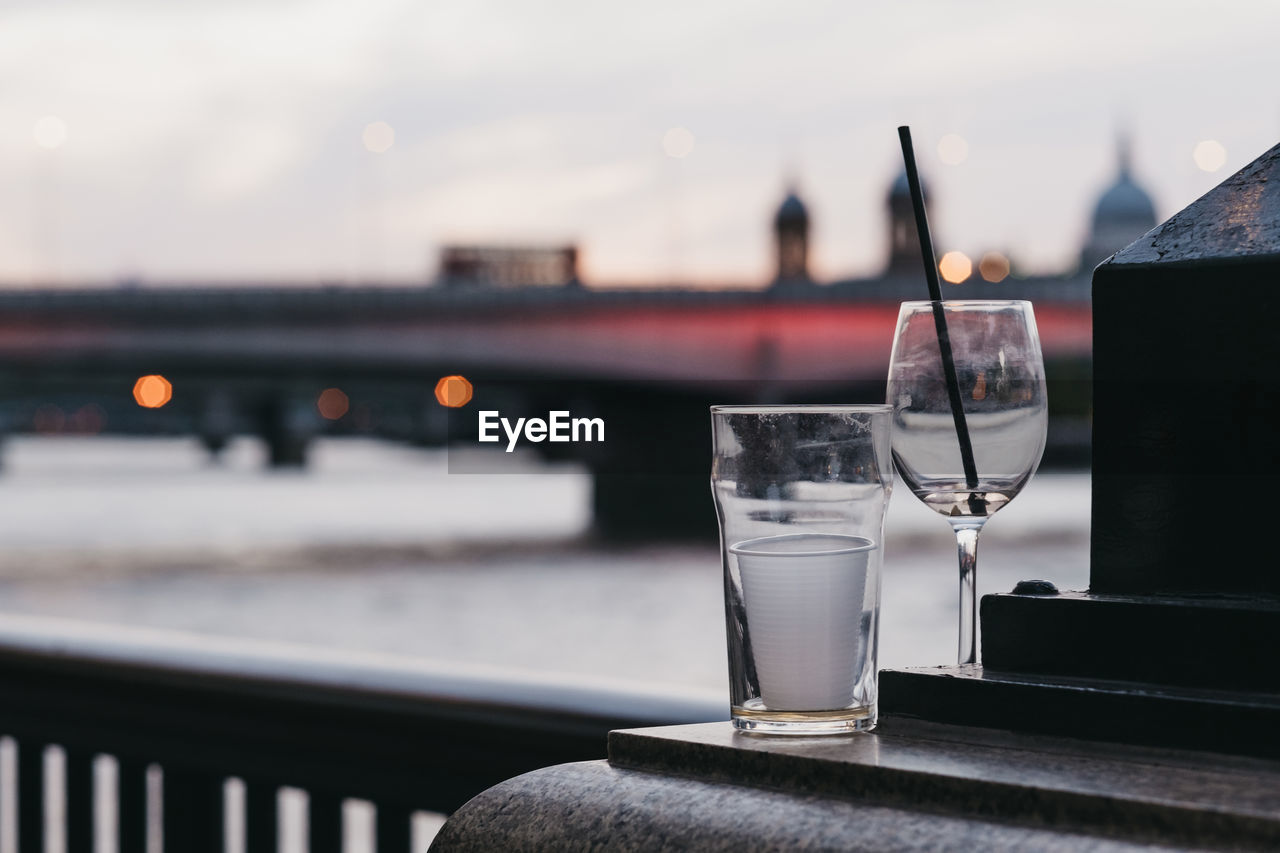 Empty glasses left outside in london, uk, city on the background, selective focus.