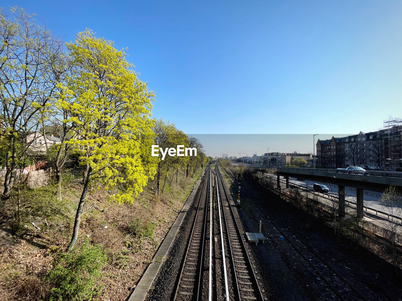 Spring time view of berlin s-bahn railroad tracks against clear sky with tv tower in background 