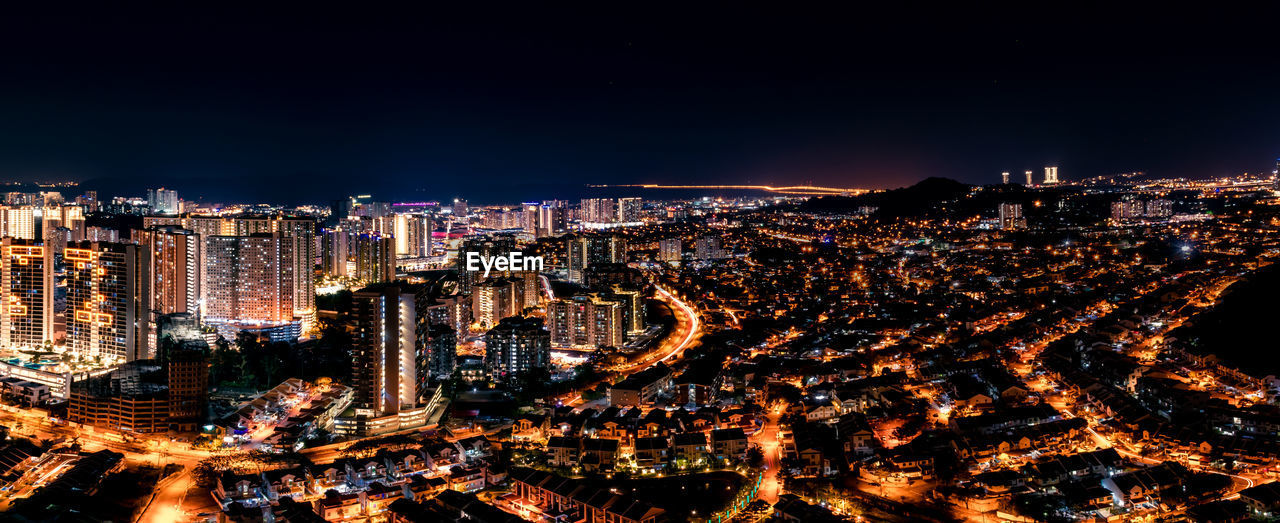 High angle view of illuminated city buildings at night