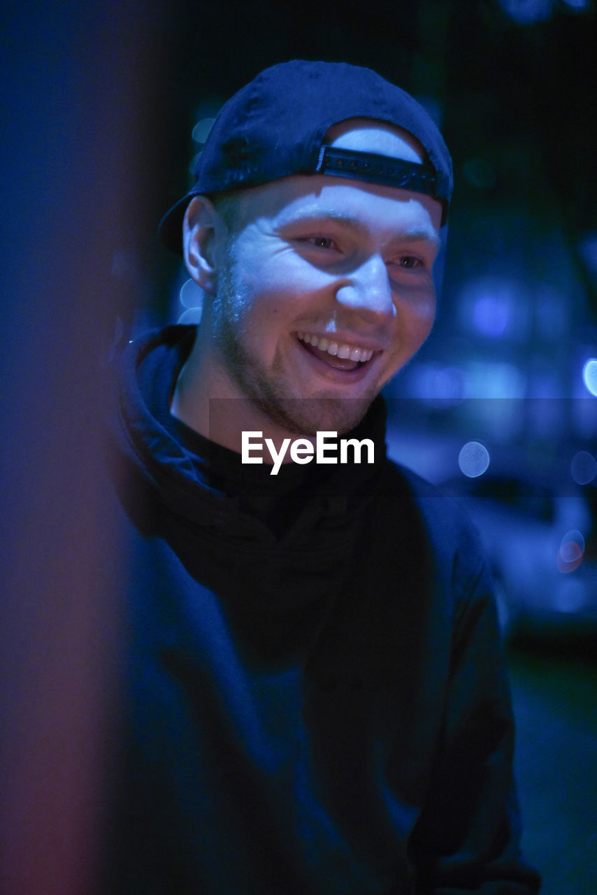 Close-up of smiling man at night