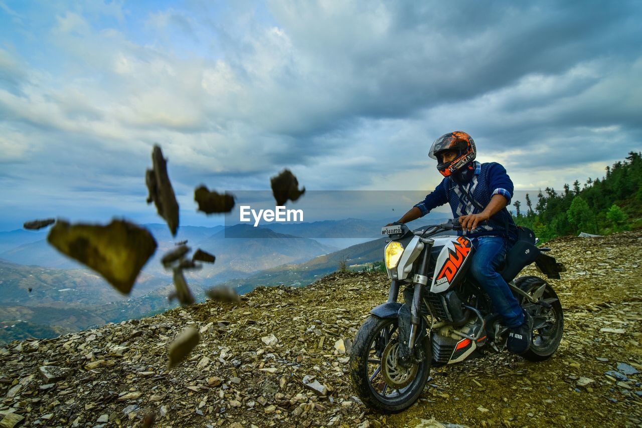 MAN RIDING MOTORCYCLE