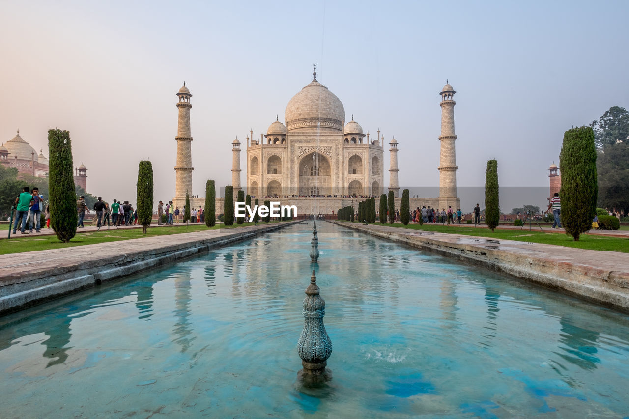 View of fountain with taj mahal against sky