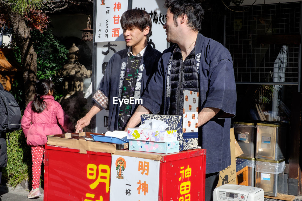 People at kanda shrine on sunny day