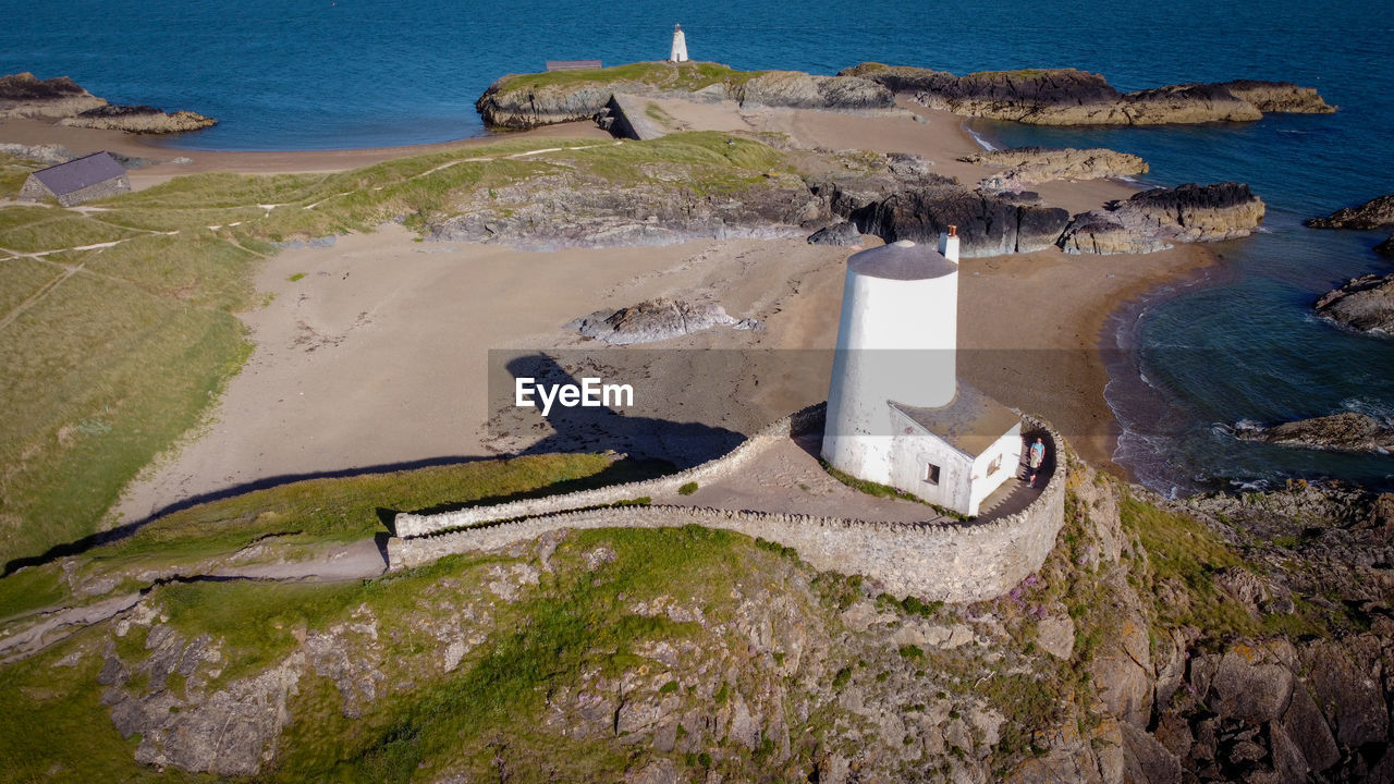 High angle view of lighthouse and rocks on beach