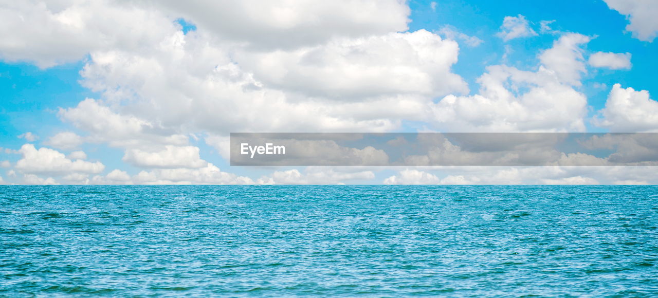 PANORAMIC VIEW OF SEA AGAINST CLOUDY SKY