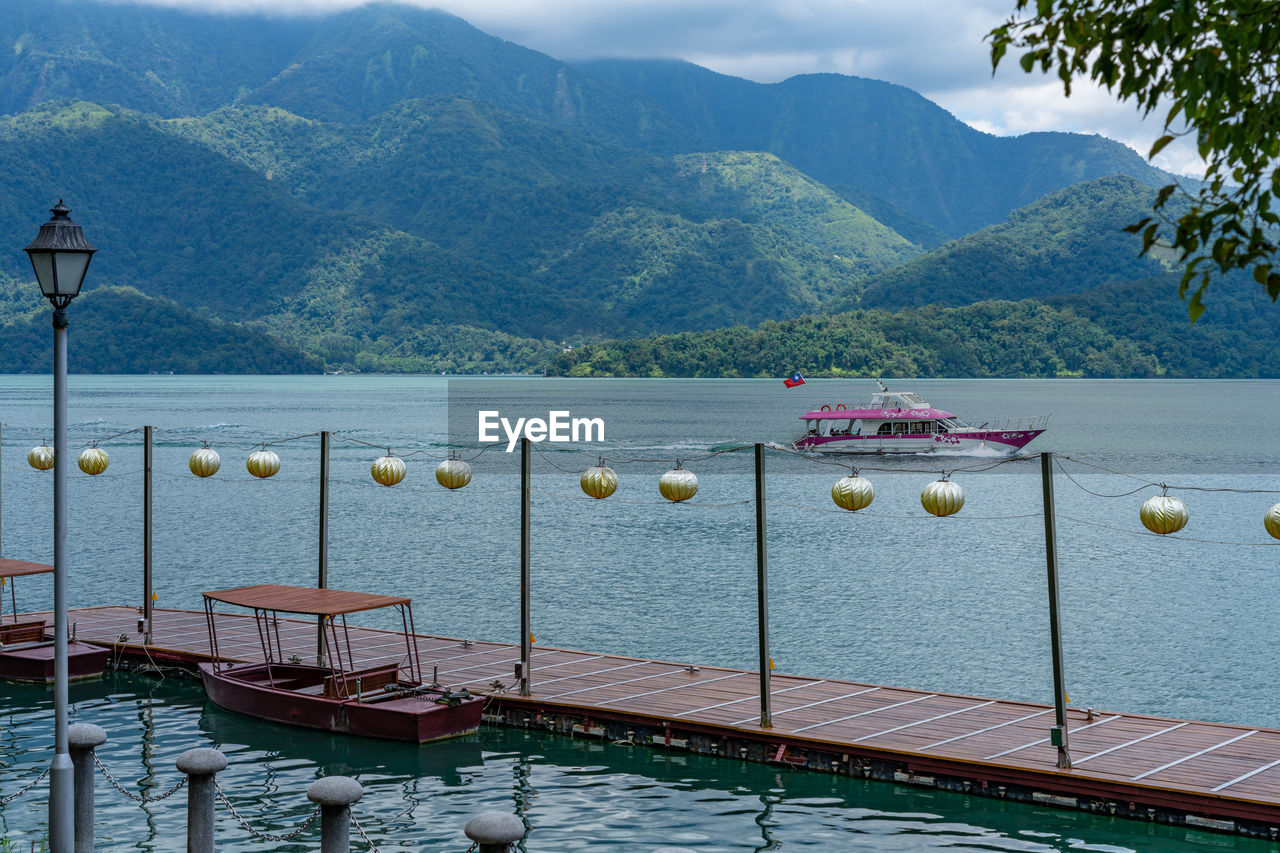 SCENIC VIEW OF LAKE BY MOUNTAINS