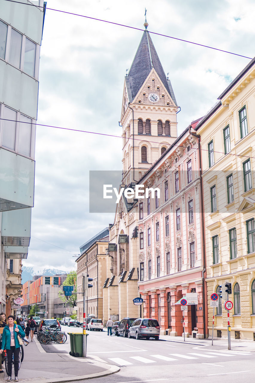 View of city street and buildings against sky