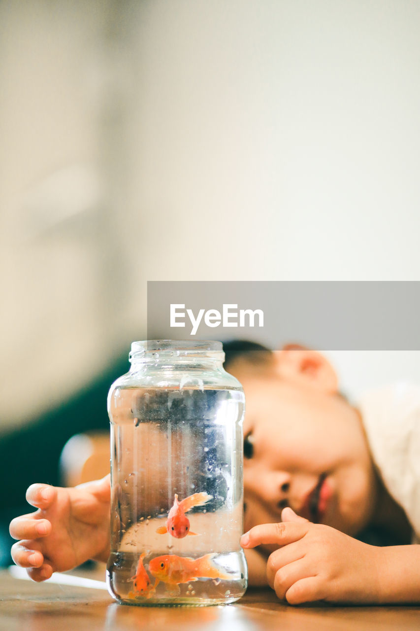 Midsection of boy holding glass