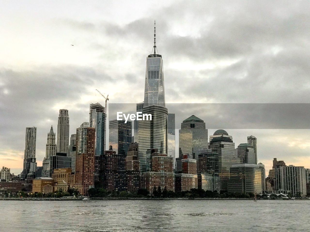 View of buildings in city against cloudy sky