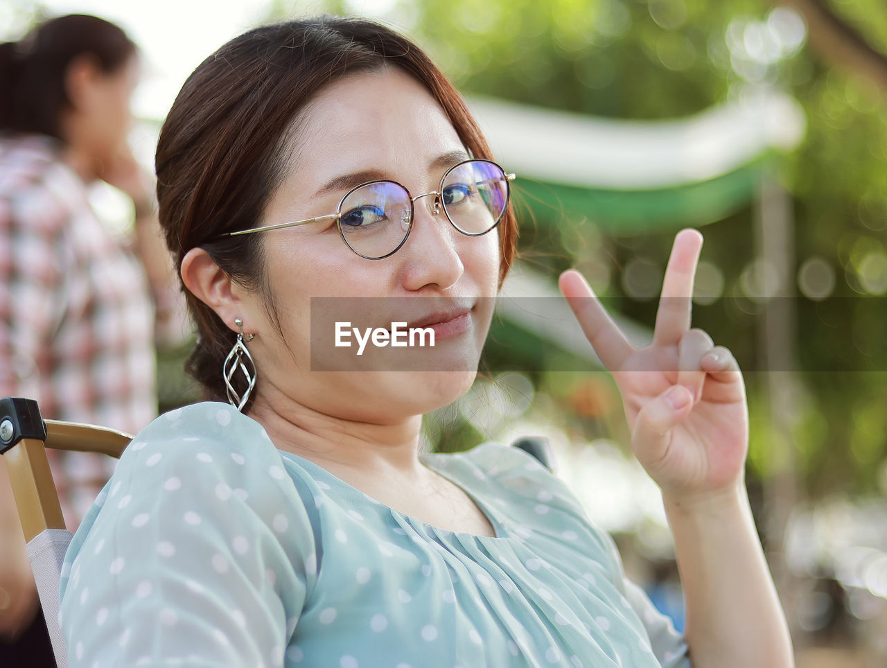 Portrait close-up lifestyle smart caucasian woman wearing glasses sitting smiling happy face 