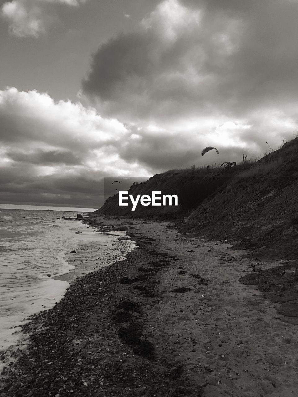 SCENIC VIEW OF SEA WITH MOUNTAIN IN BACKGROUND