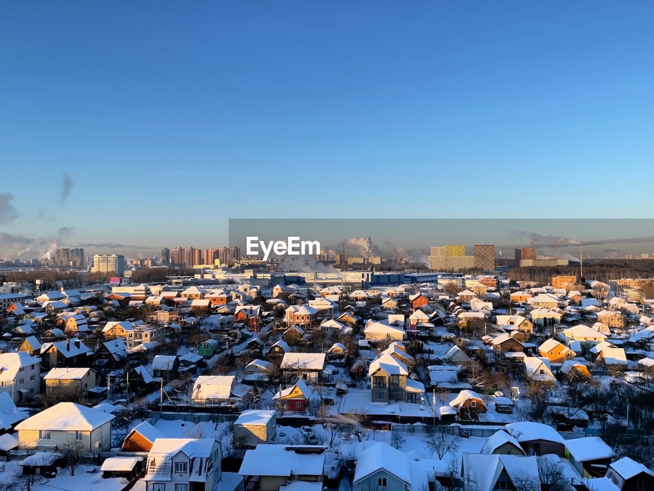 High angle view of townscape against blue sky during winter