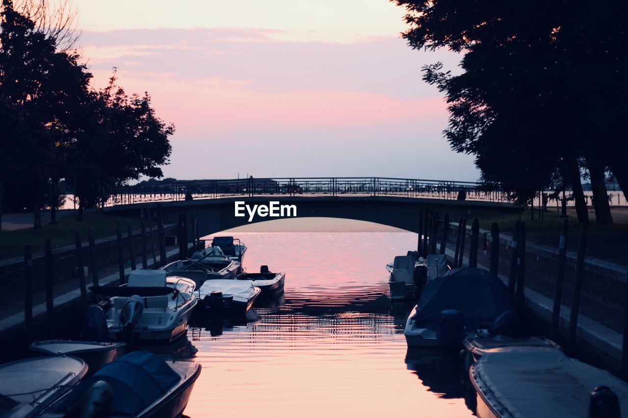 VIEW OF BRIDGE OVER RIVER AGAINST SKY DURING SUNSET