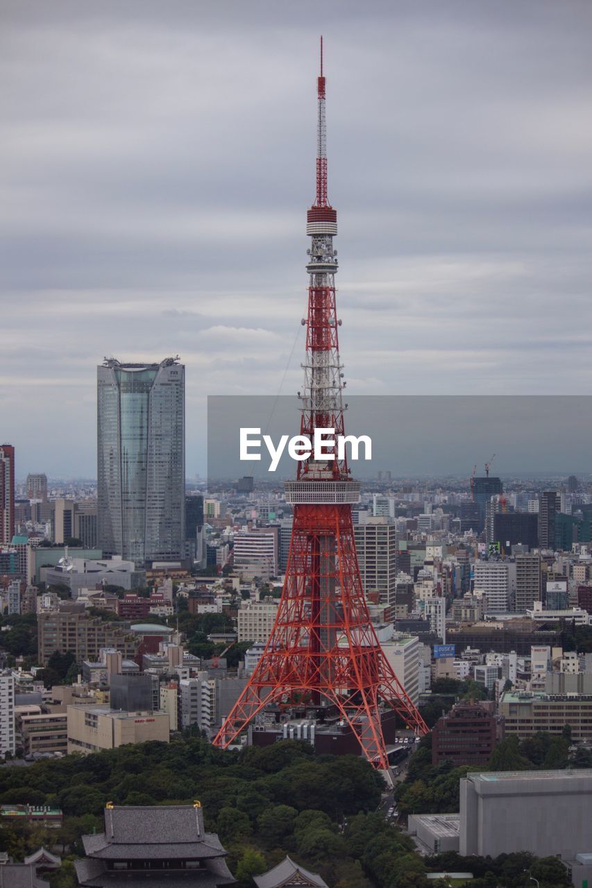 Tower in city against sky