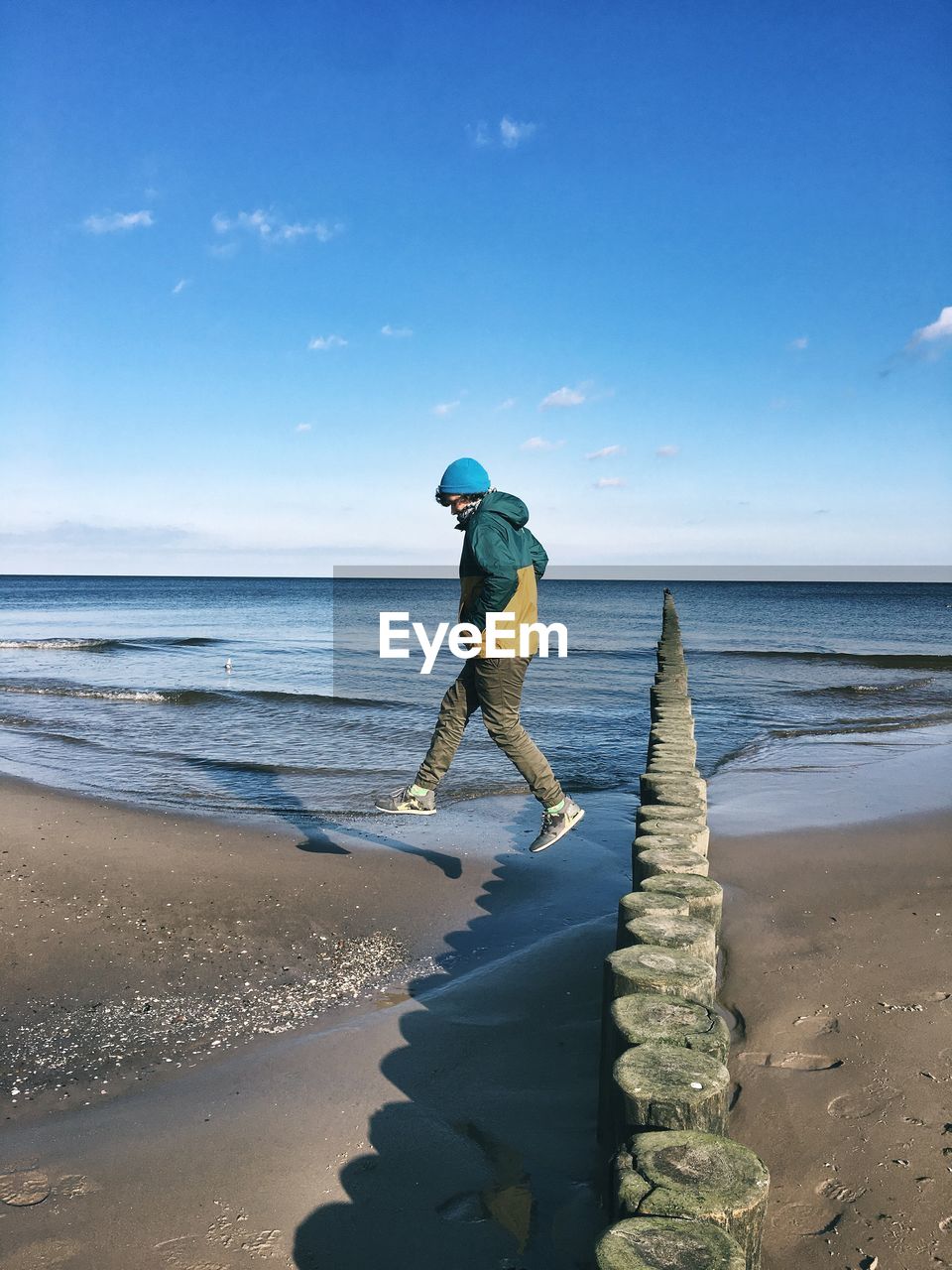 Full length of man on beach against sky