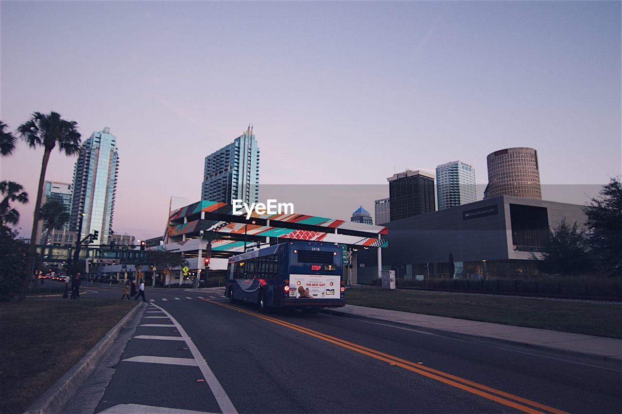 Road in city against clear sky