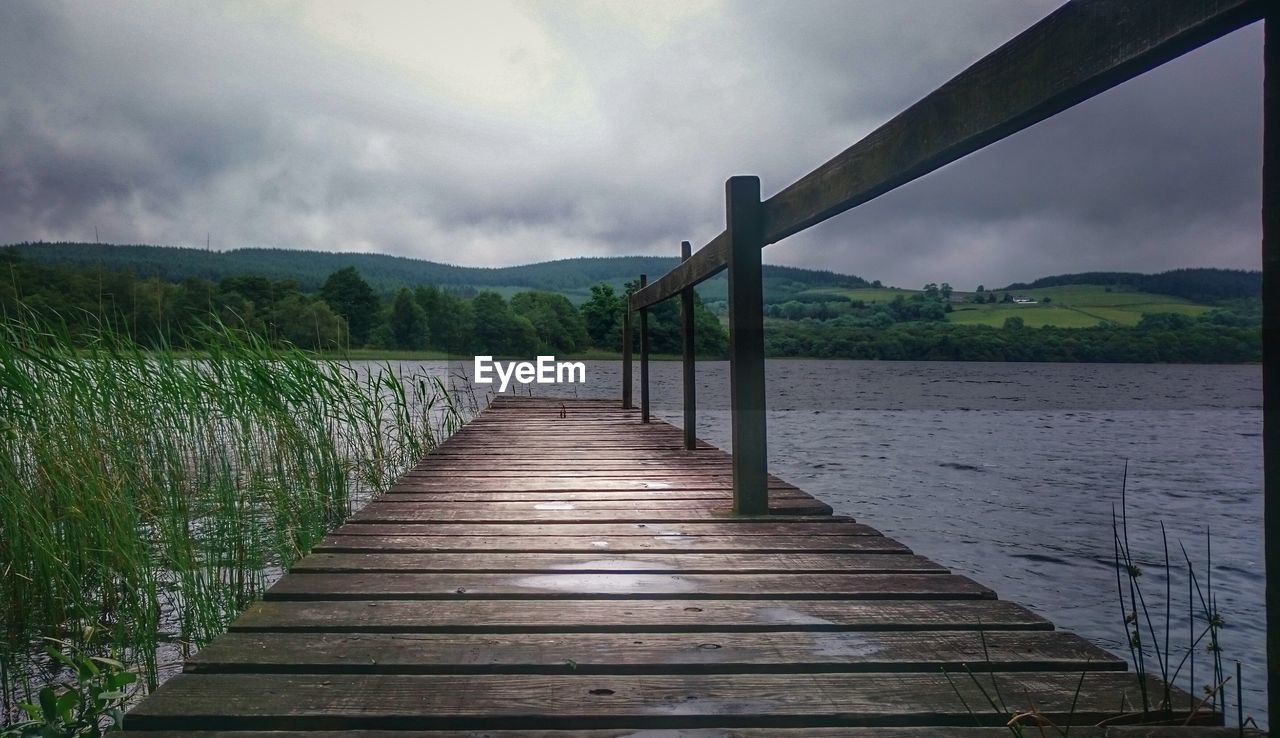 WOODEN PIER LEADING TOWARDS SEA