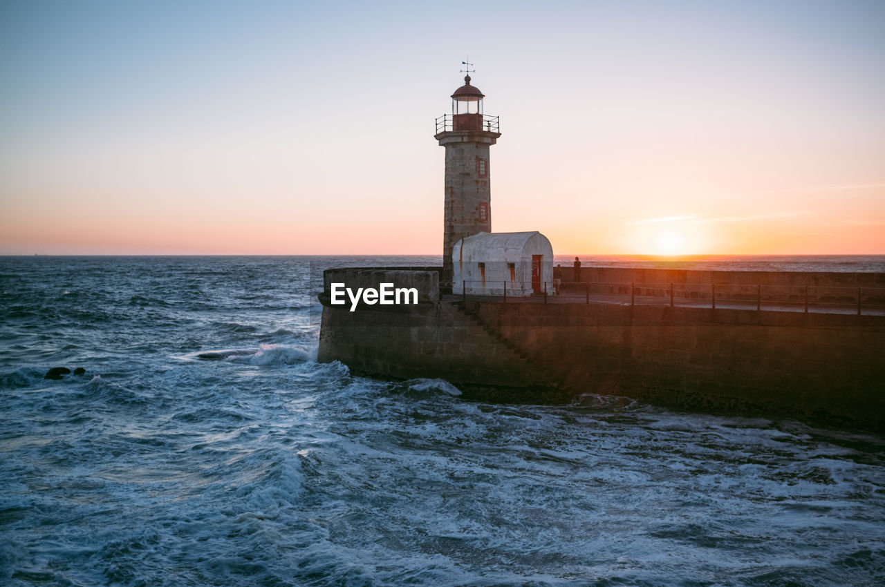 Scenic view of lighthouse at sunset