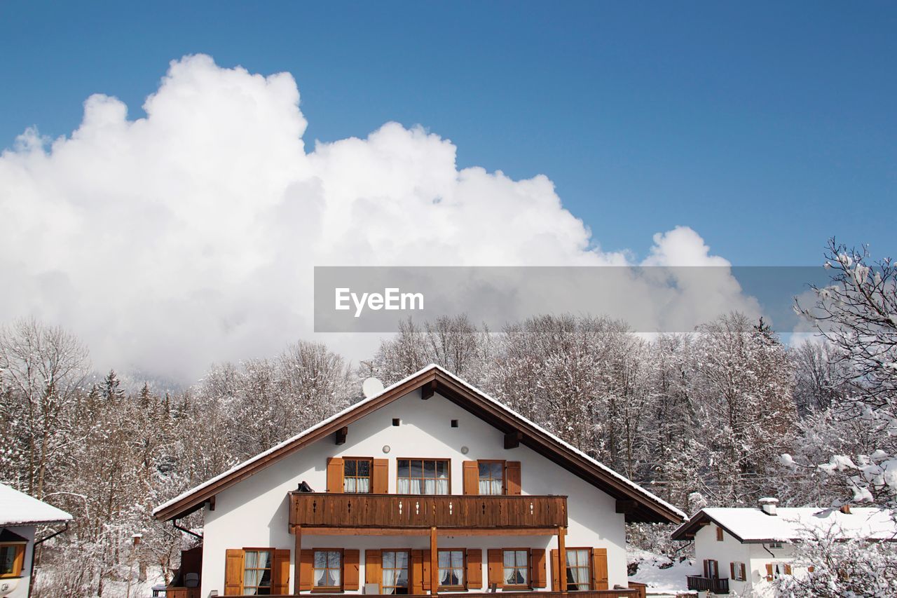 HOUSE AND BUILDINGS AGAINST SKY