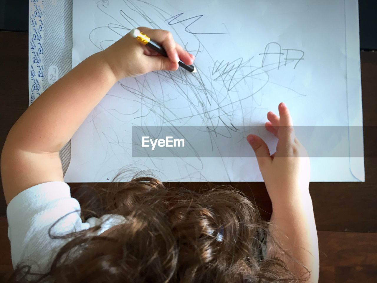 High angle view of child drawing