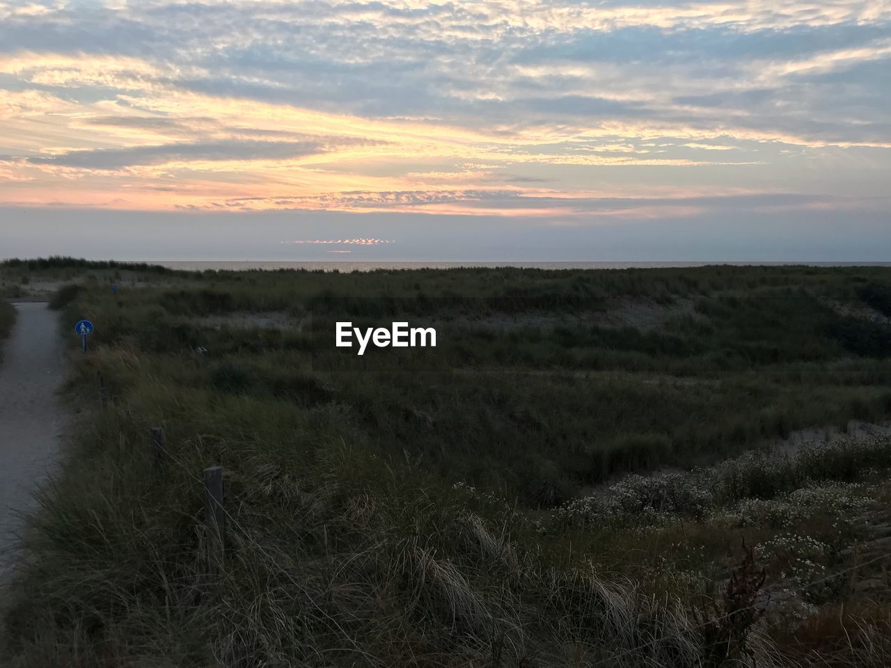 SCENIC VIEW OF LAND DURING SUNSET