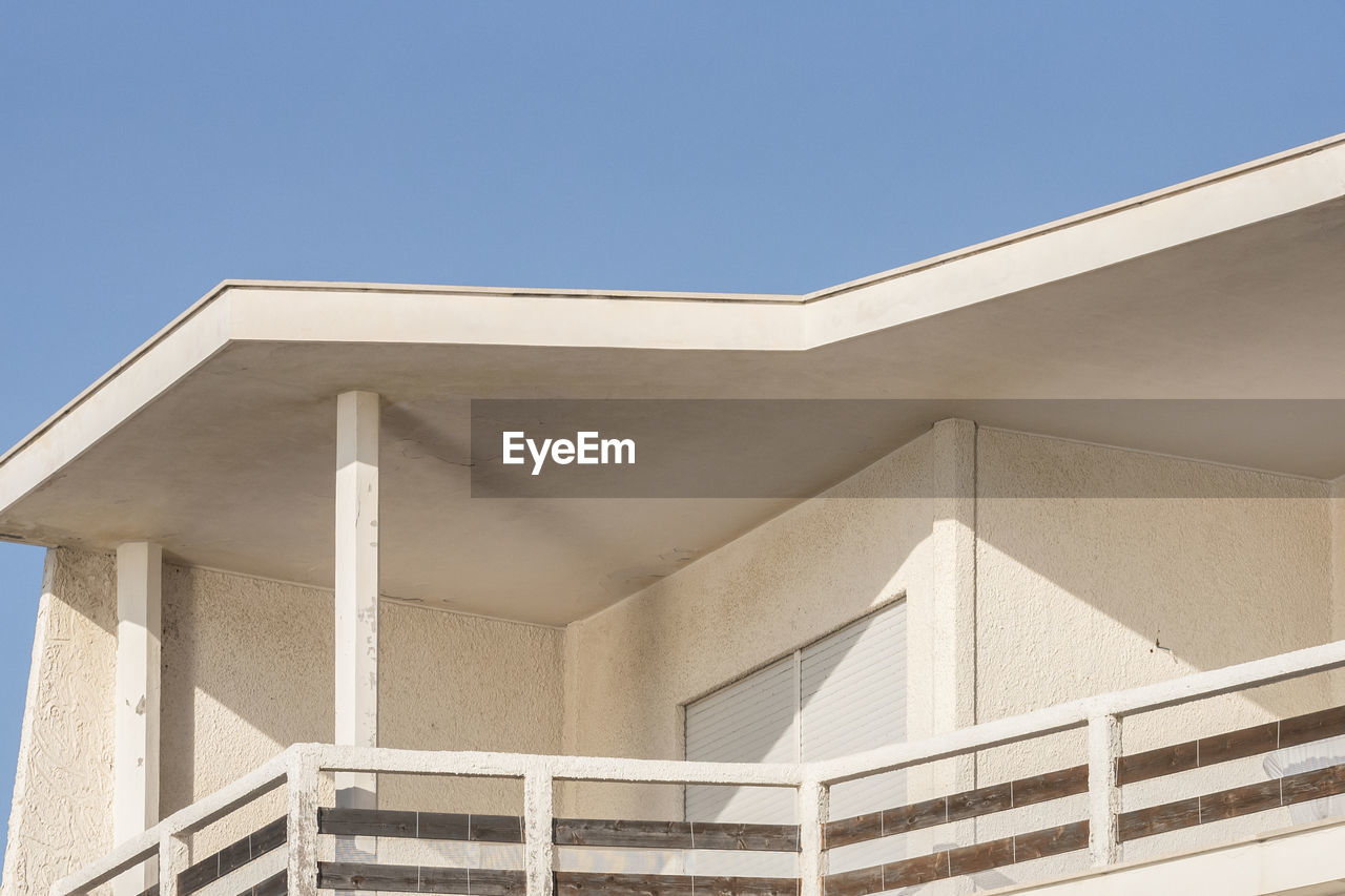 Low angle view of building against clear blue sky