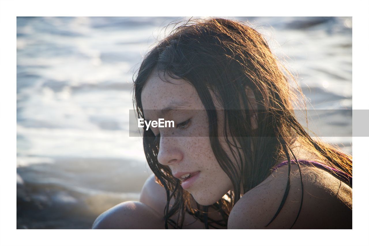 Close-up portrait of young woman on beach