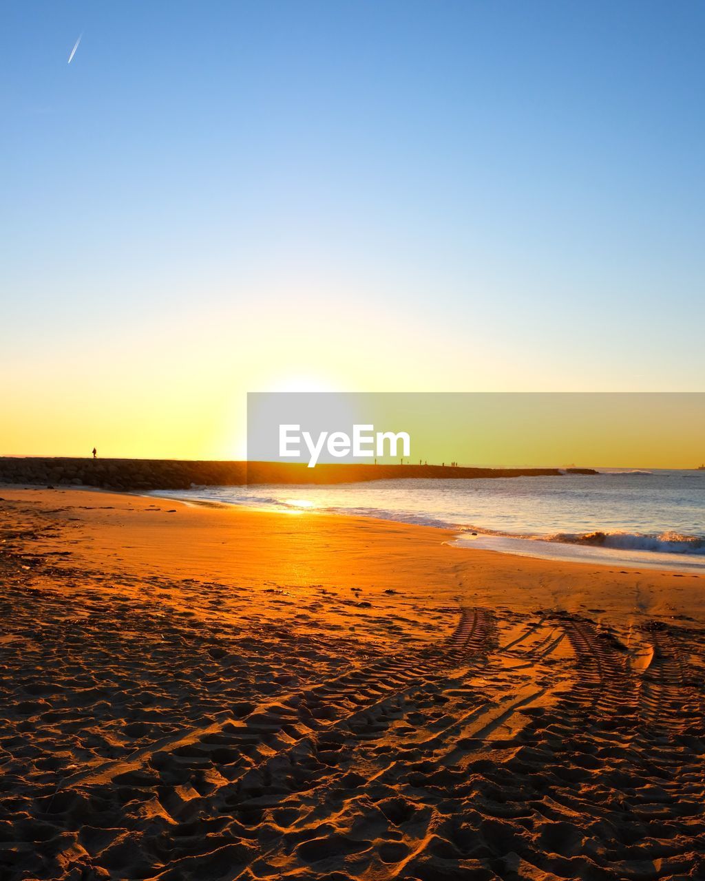 Scenic view of beach against sky during sunset