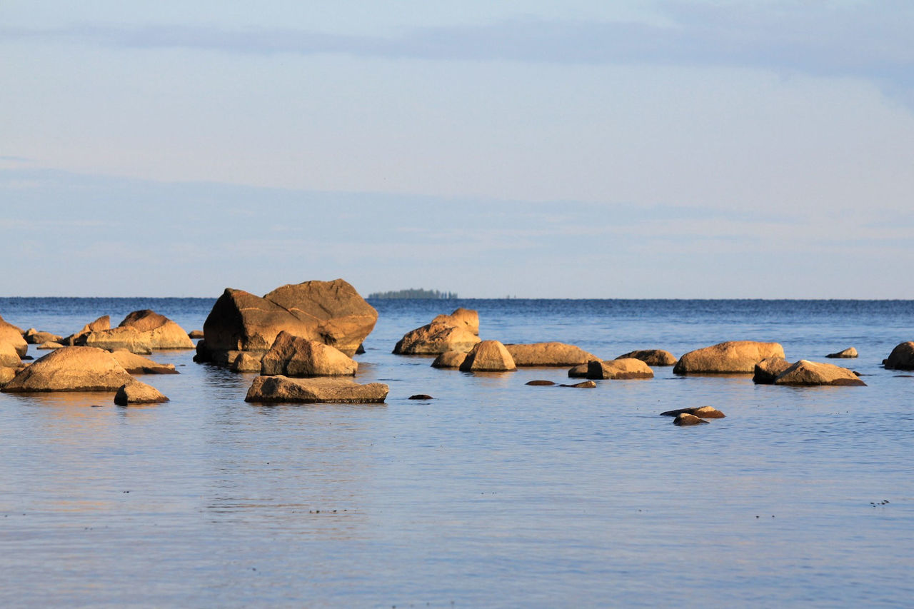 ROCKS ON SEA AGAINST SKY