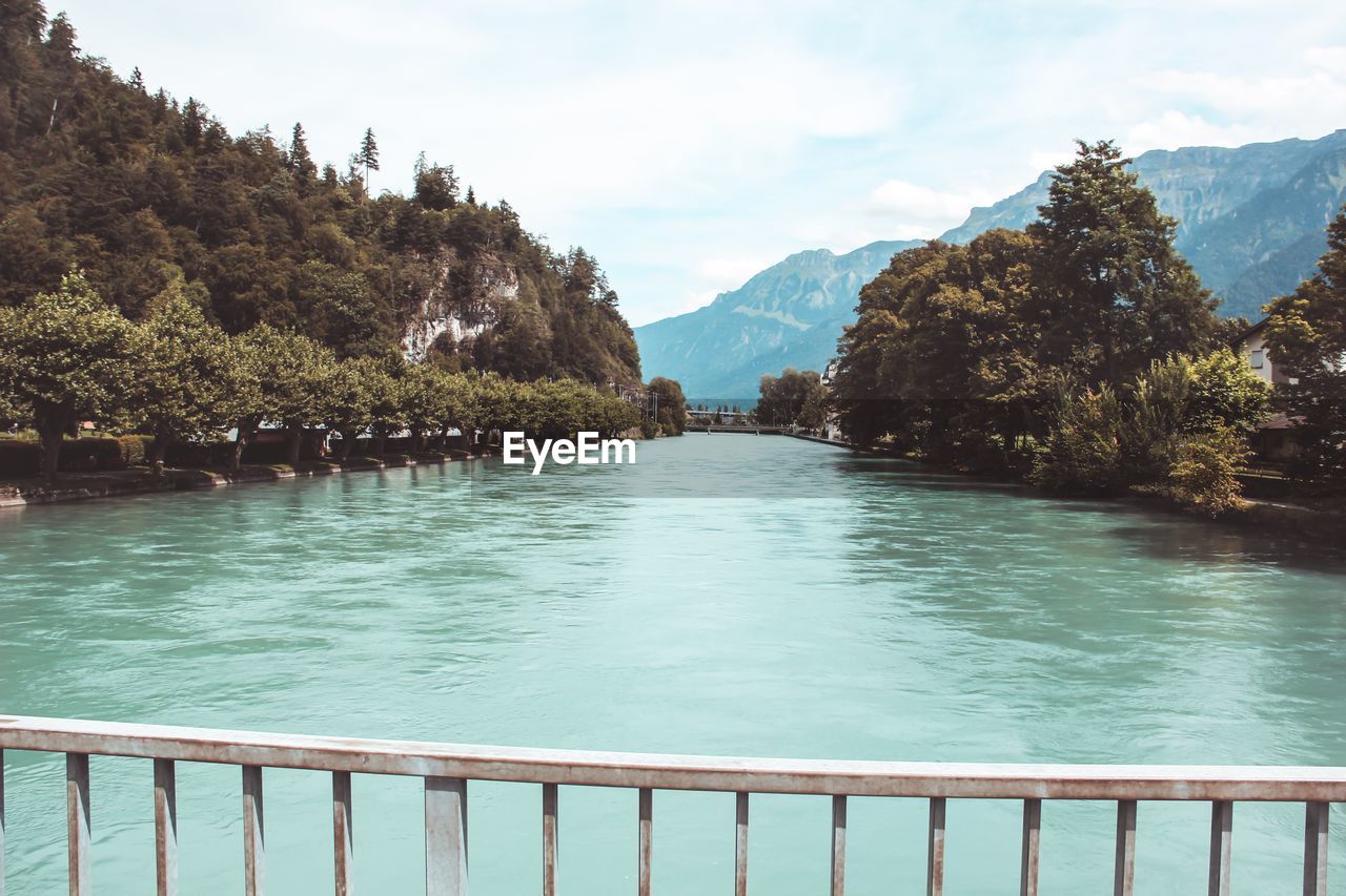 SCENIC VIEW OF SWIMMING POOL BY LAKE