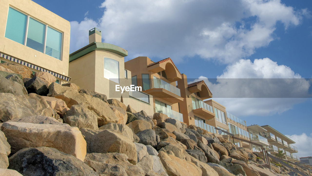 architecture, sky, built structure, rock, cloud, building exterior, nature, building, wall, house, vacation, industry, outdoors, no people, blue, landmark, land, travel destinations, travel, construction industry, stone material