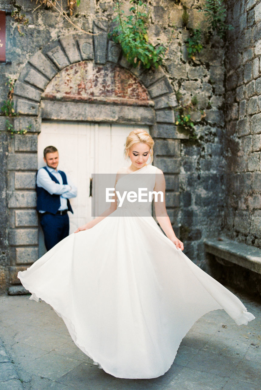 low angle view of wedding dress standing against wall