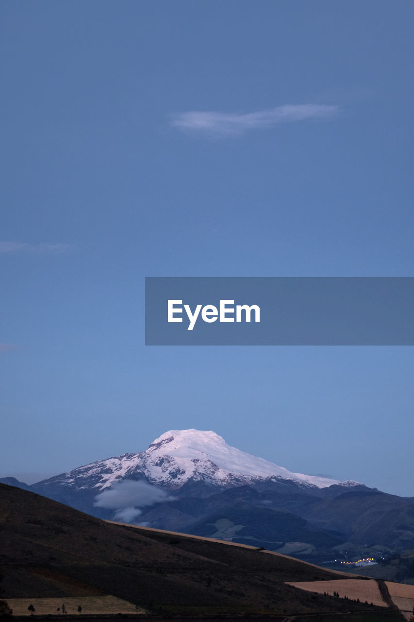 Scenic view of cayambe volcano in ecuador, during blue hour.