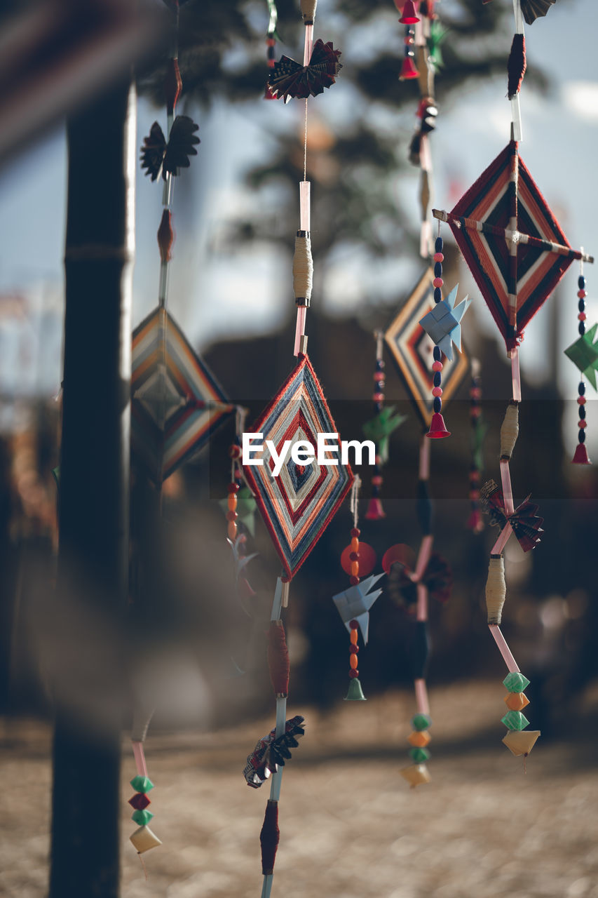 Low angle view of wind chimes hanging outdoors