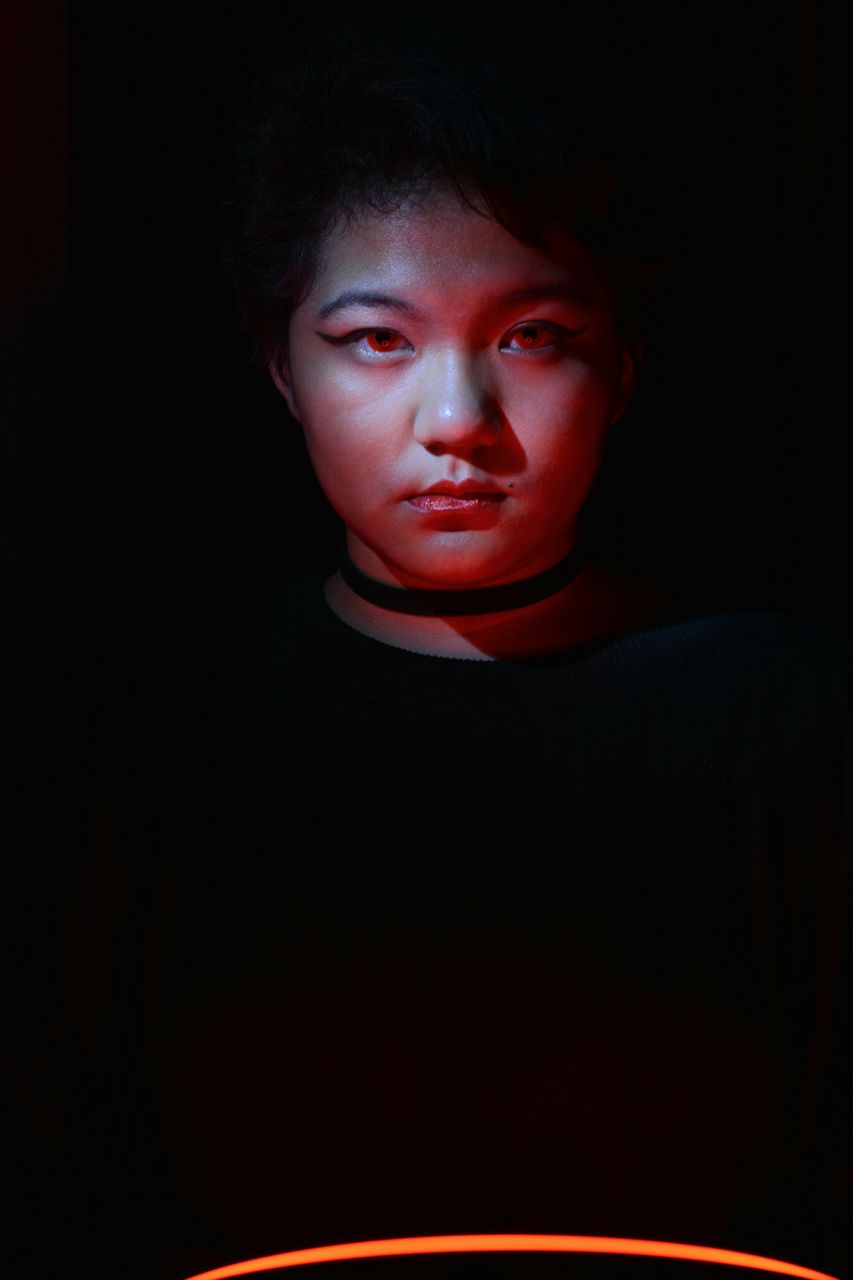 portrait, one person, red, darkness, indoors, looking at camera, headshot, black background, dark, studio shot, front view, young adult, adult, human face, child, emotion, serious, women, copy space, person