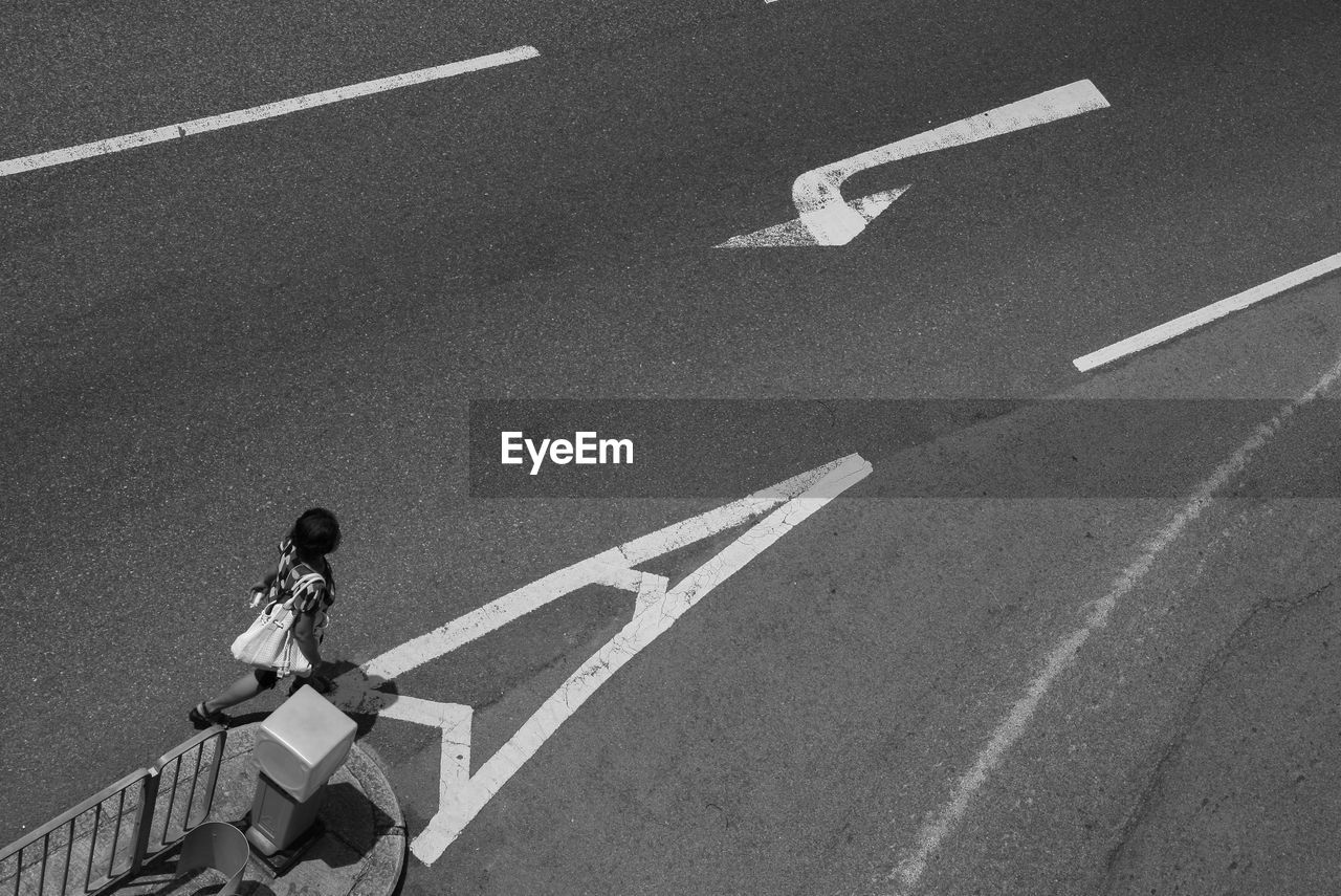 High angle view of woman crossing road