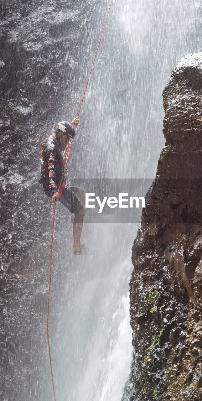 Person standing on rock in water