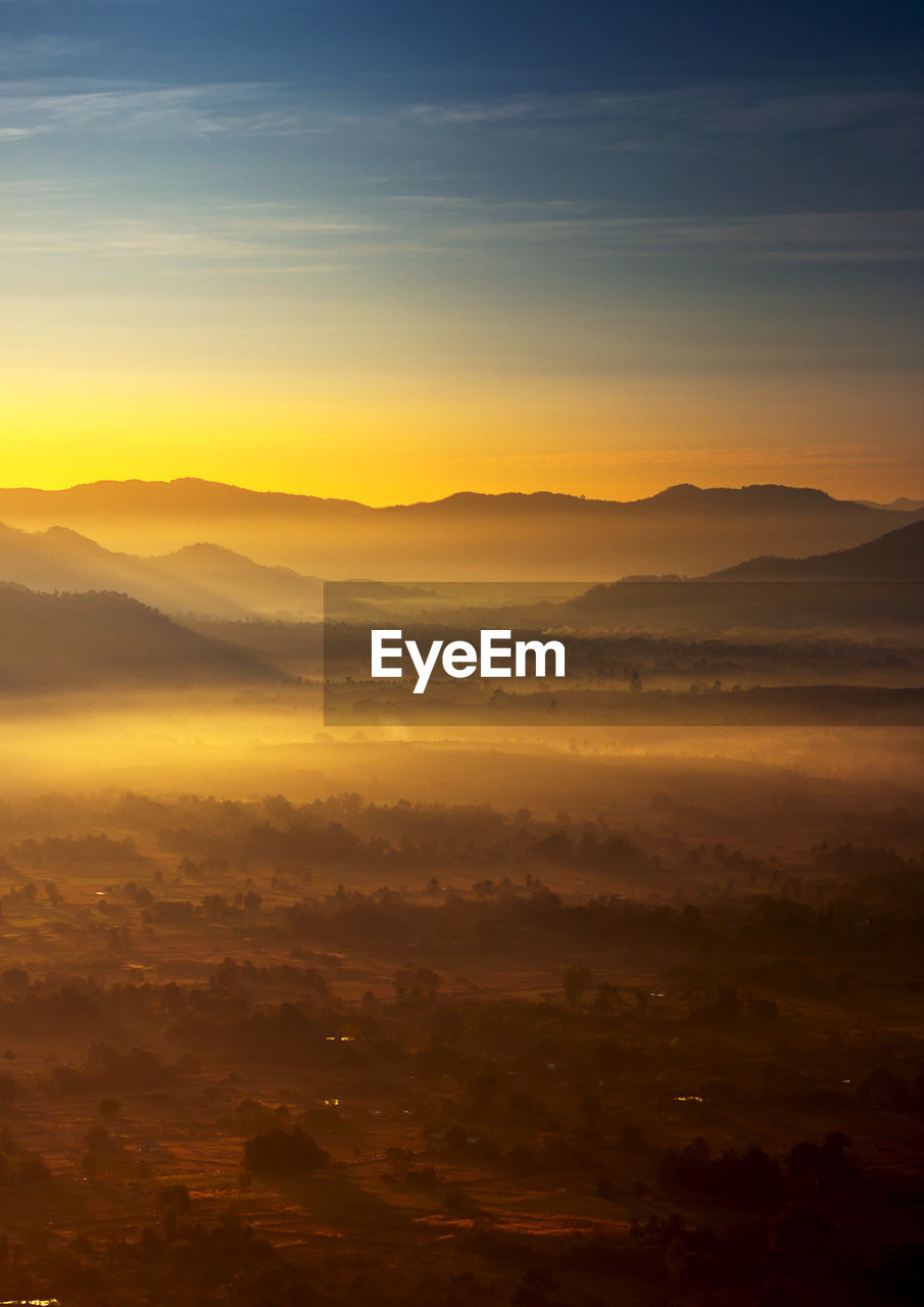 Scenic view of silhouette mountains against sky during sunset