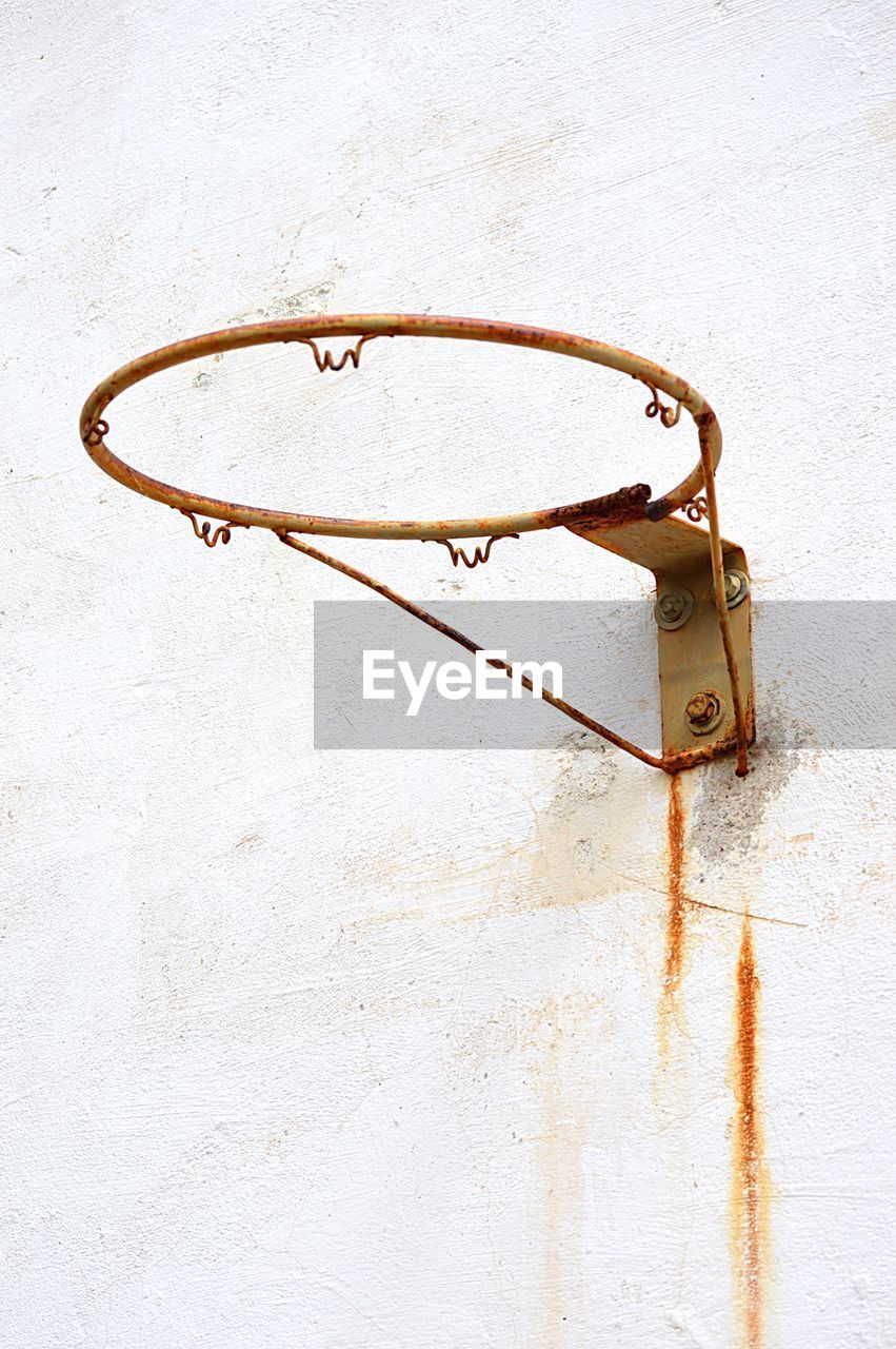 High angle view of rusty basketball hoop against wall