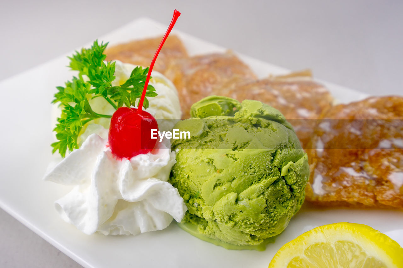 CLOSE-UP OF ICE CREAM WITH FRUITS
