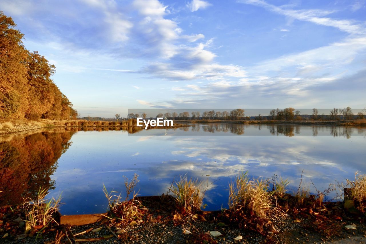 Scenic view of lake by buildings against sky