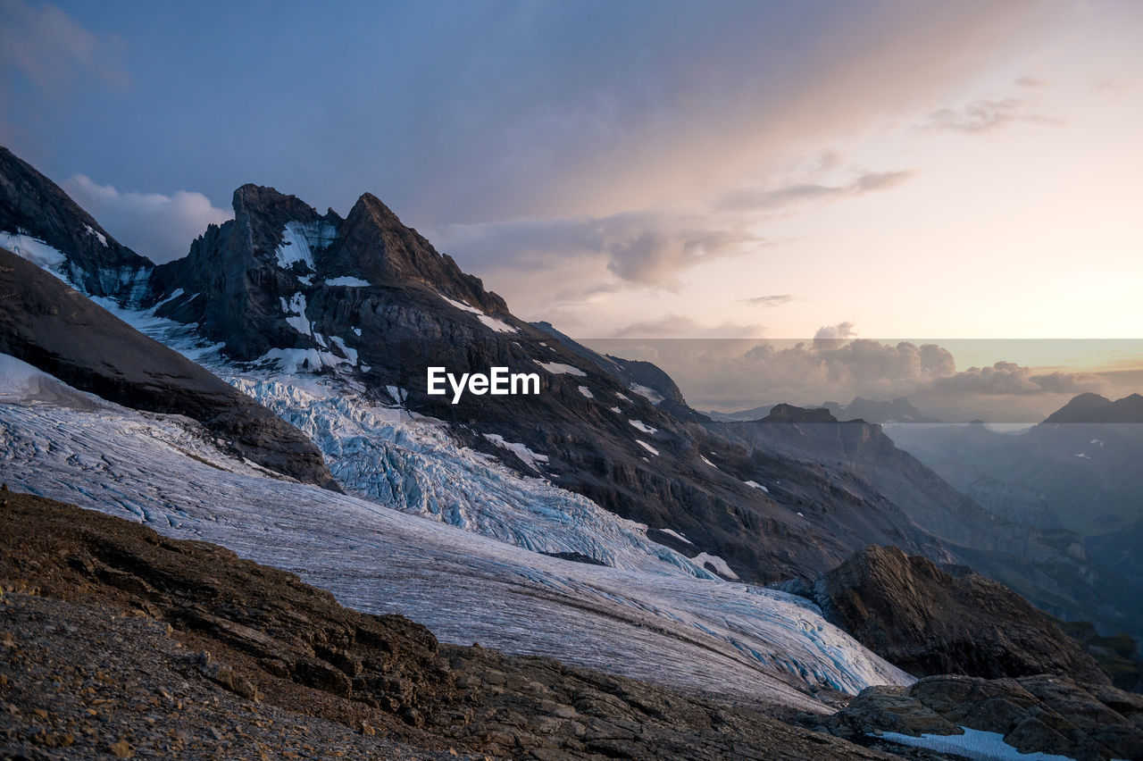 SCENIC VIEW OF MOUNTAINS AGAINST SKY DURING SUNSET