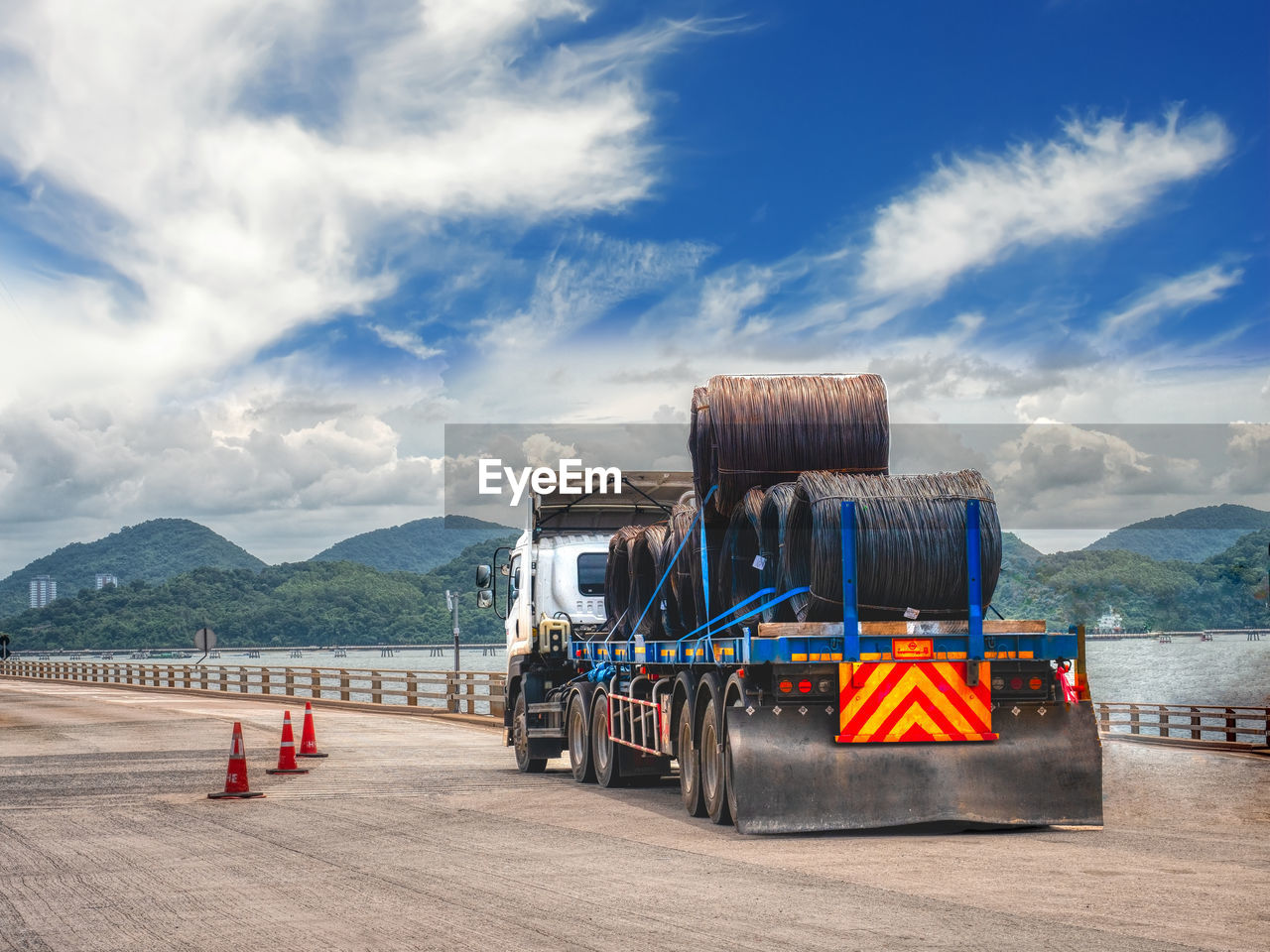 Truck receive steel wire rod from port to store at warehouse.