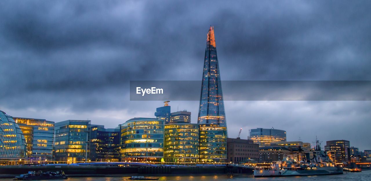 View of skyscrapers against cloudy sky