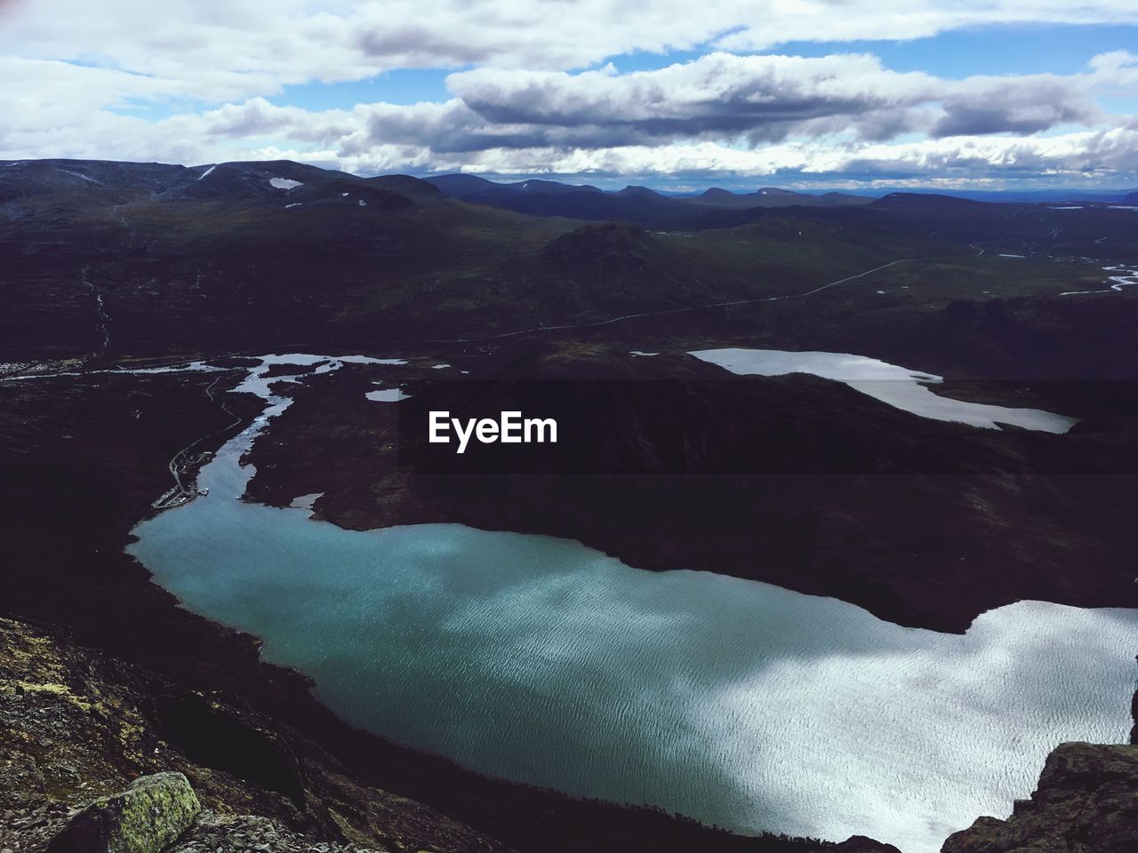 Scenic view of lake and mountains against sky