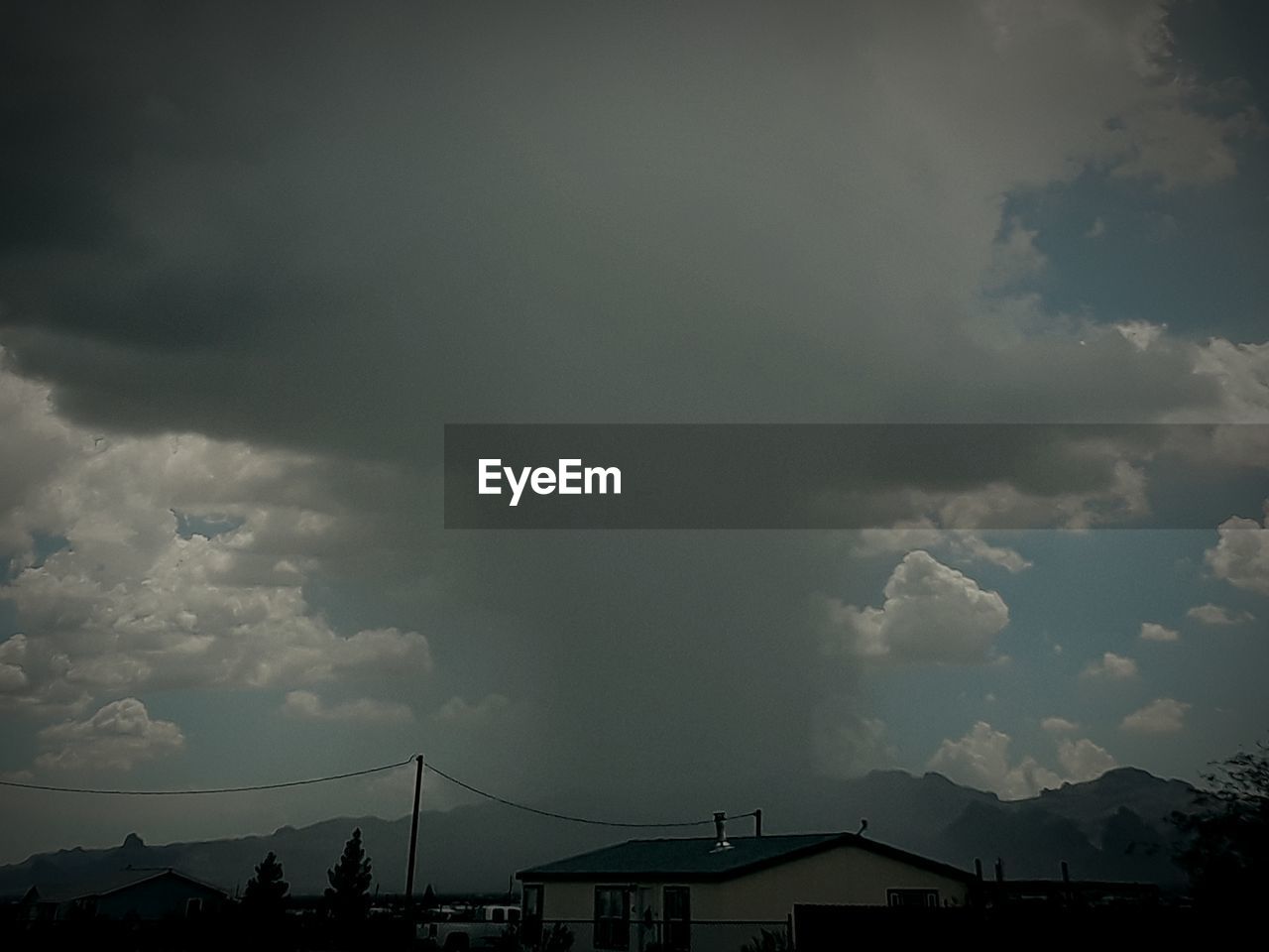 LOW ANGLE VIEW OF STORM CLOUDS OVER CITY