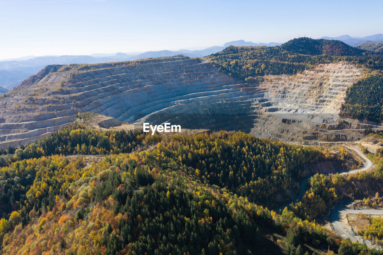 Flying above an open pit mine, copper excavation in rosia poieni, romania. aerial drone view