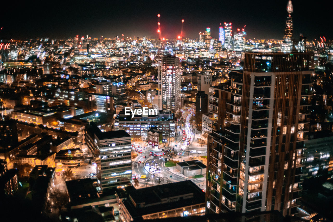 Aerial view of city lit up at night