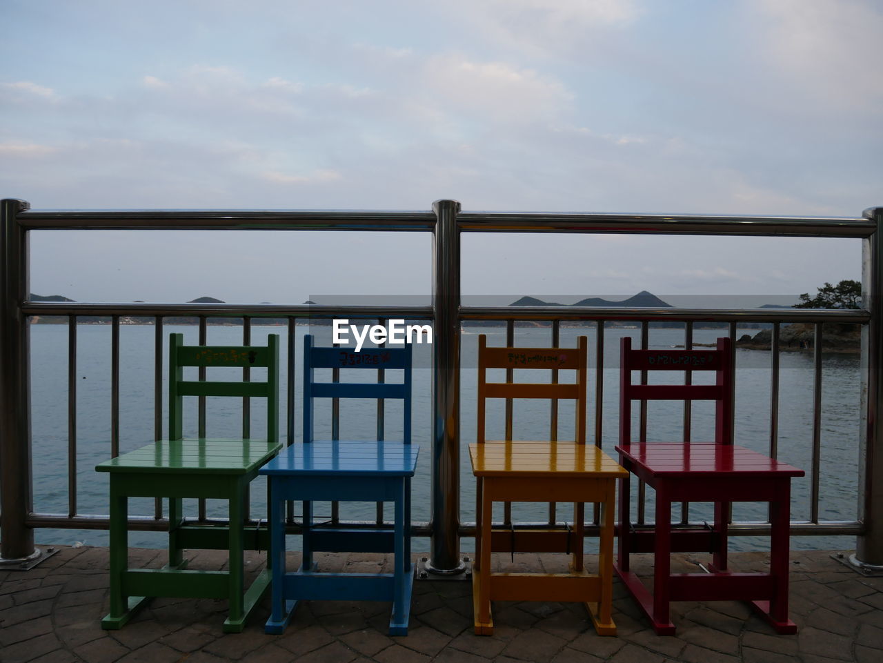 CHAIRS AND BEACH AGAINST SKY