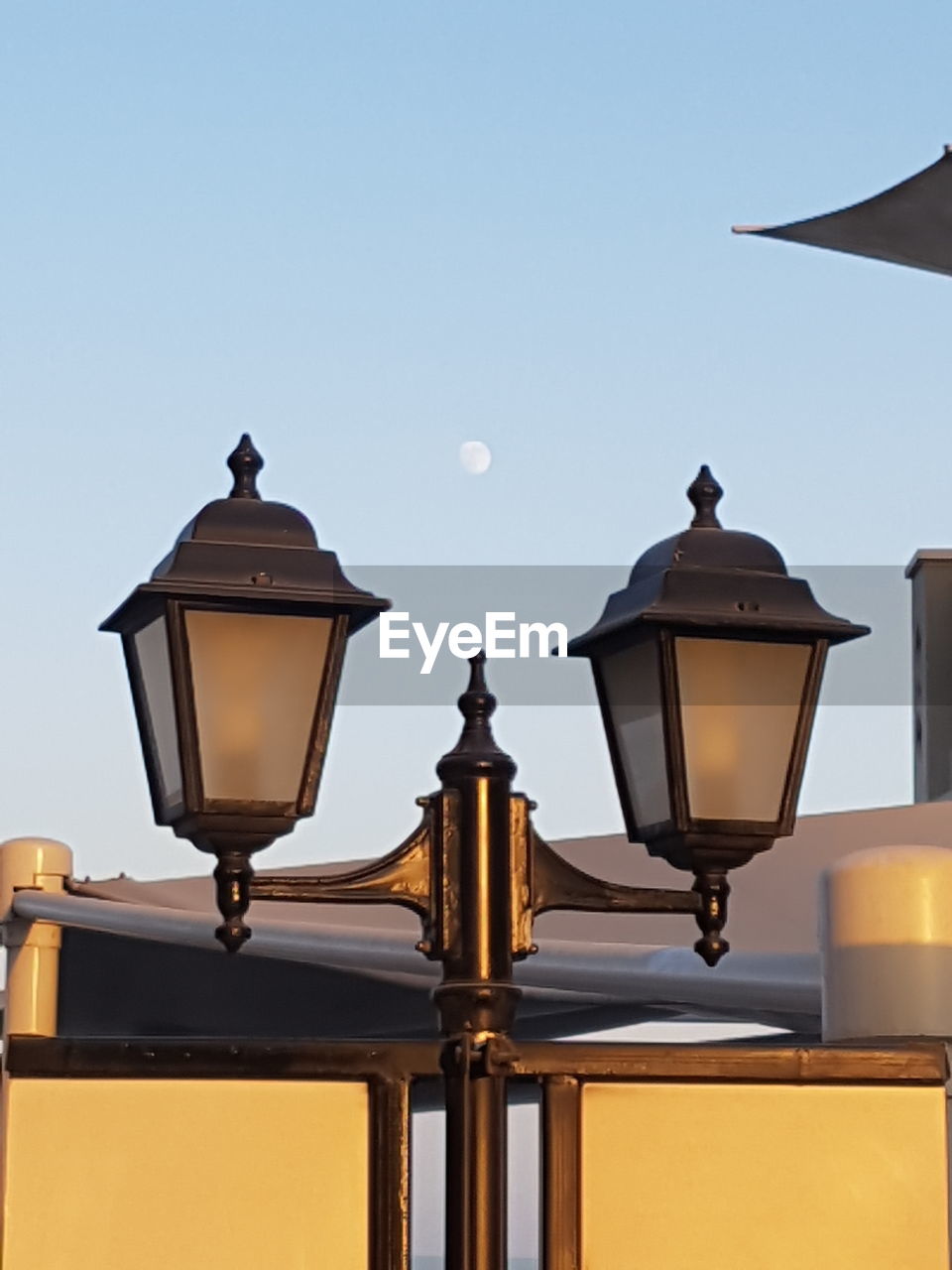 LOW ANGLE VIEW OF ILLUMINATED STREET LIGHT AGAINST SKY